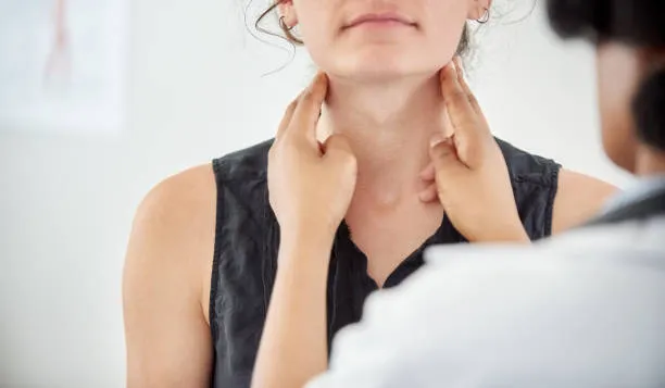 Thyroid Disorders - drpallavichauhan Medical professional palpating a patient's neck to check the thyroid area.